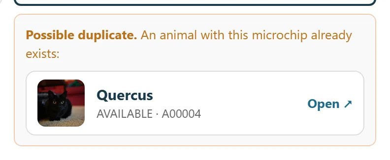 The intake form flagging a possible duplicate: an animal with this microchip already exists, showing the matching record
